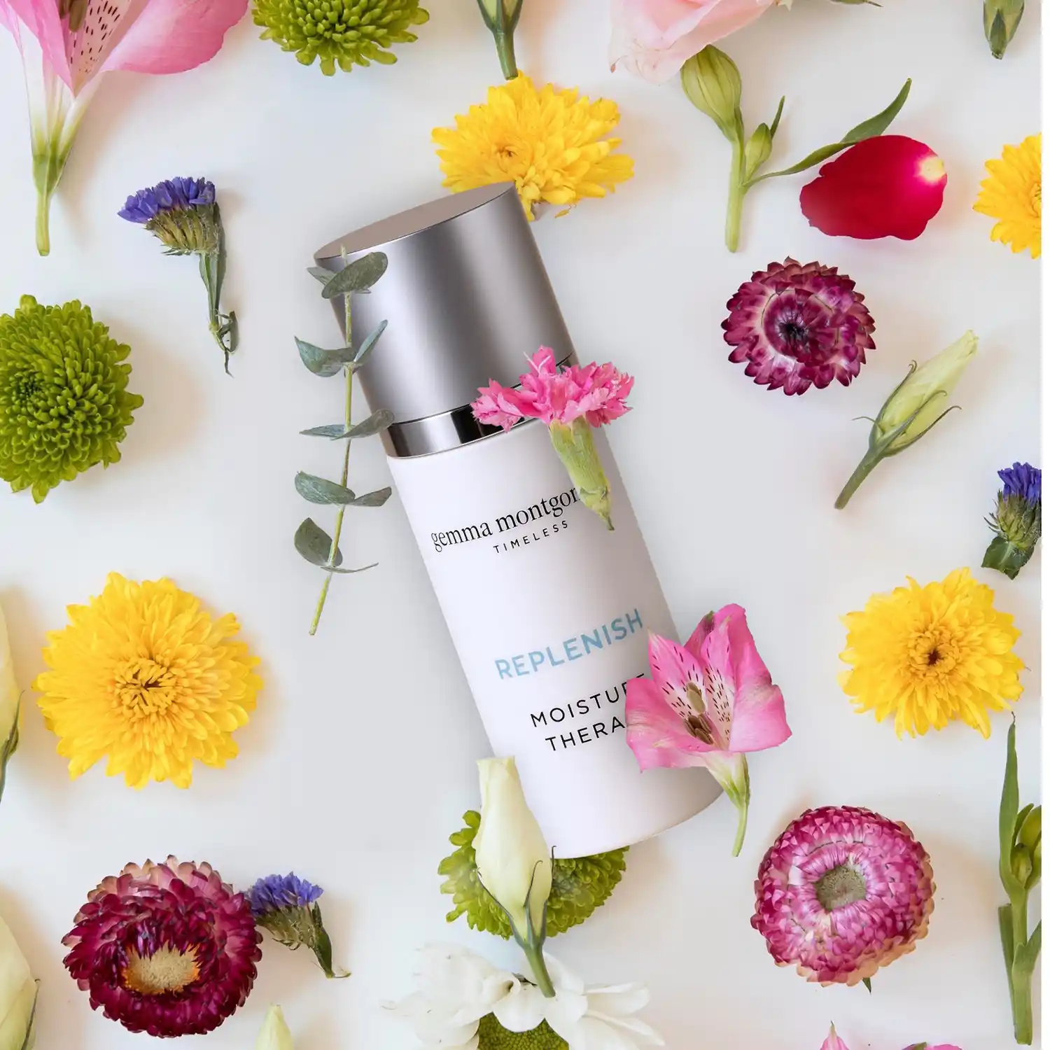 Cosmetic cream jar styled with delicate flowers — professional commercial product photography by Chaplin Studio
