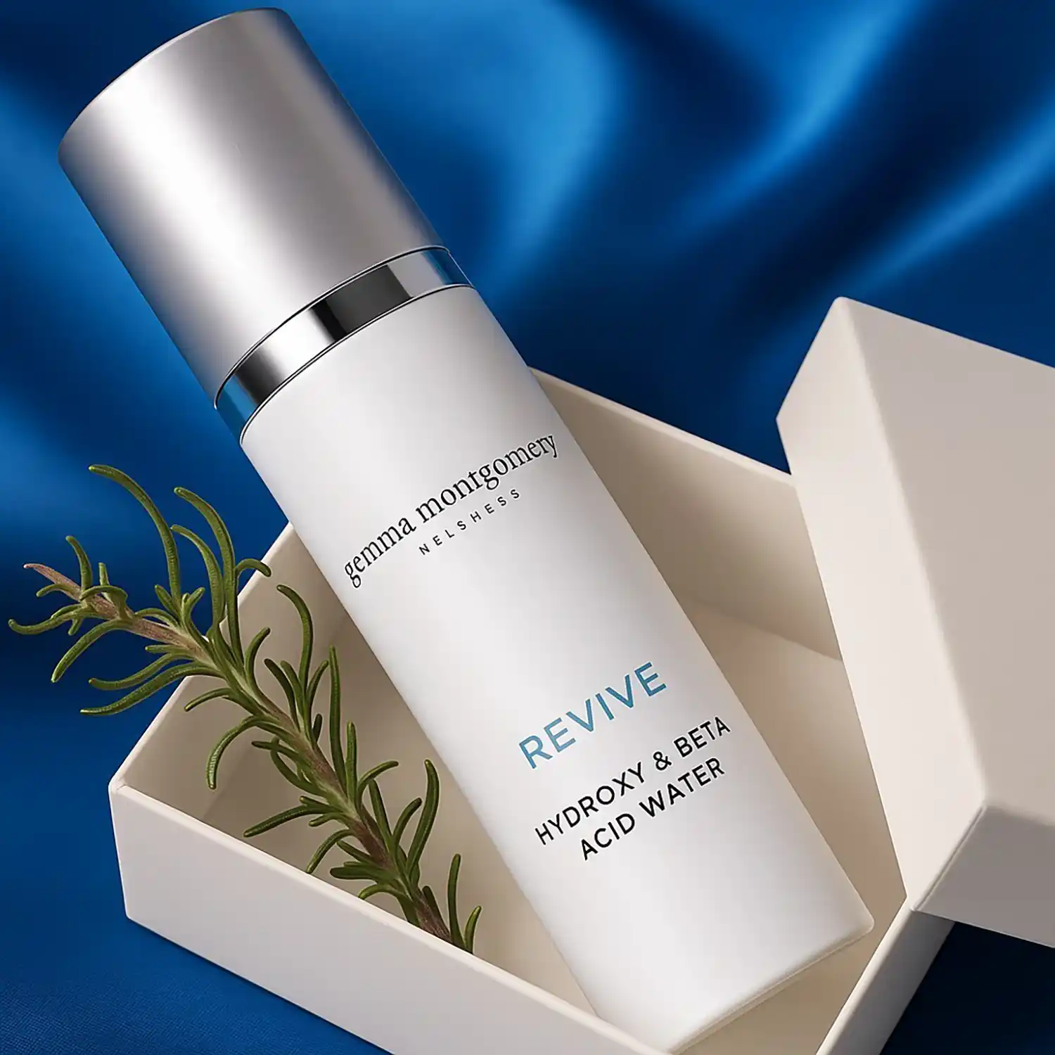 Cosmetic cream in an elegant box with blue fabric and rosemary sprig — refined commercial photo by Chaplin Studio
