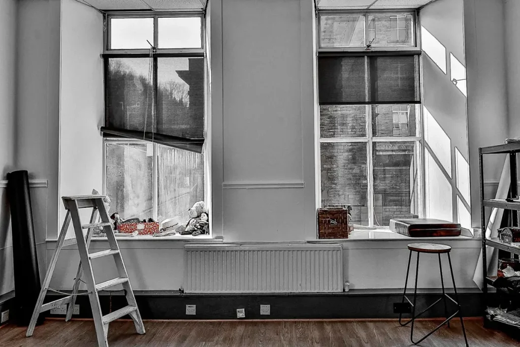 Interior of Halifax photography studio with windows, ladder, and stool. Contact information and address on page. Get in Touch with Chaplin Studio and book you Photoshoot in Halifax.