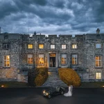 Evening wedding photoshoot at a historic manor in Halifax, newlyweds with a vintage car, captured by Chaplin Studio.