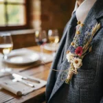 Close-up of groom's boutonnière at a rustic wedding rehearsal dinner in Halifax, capturing intimate details before the main ceremony.