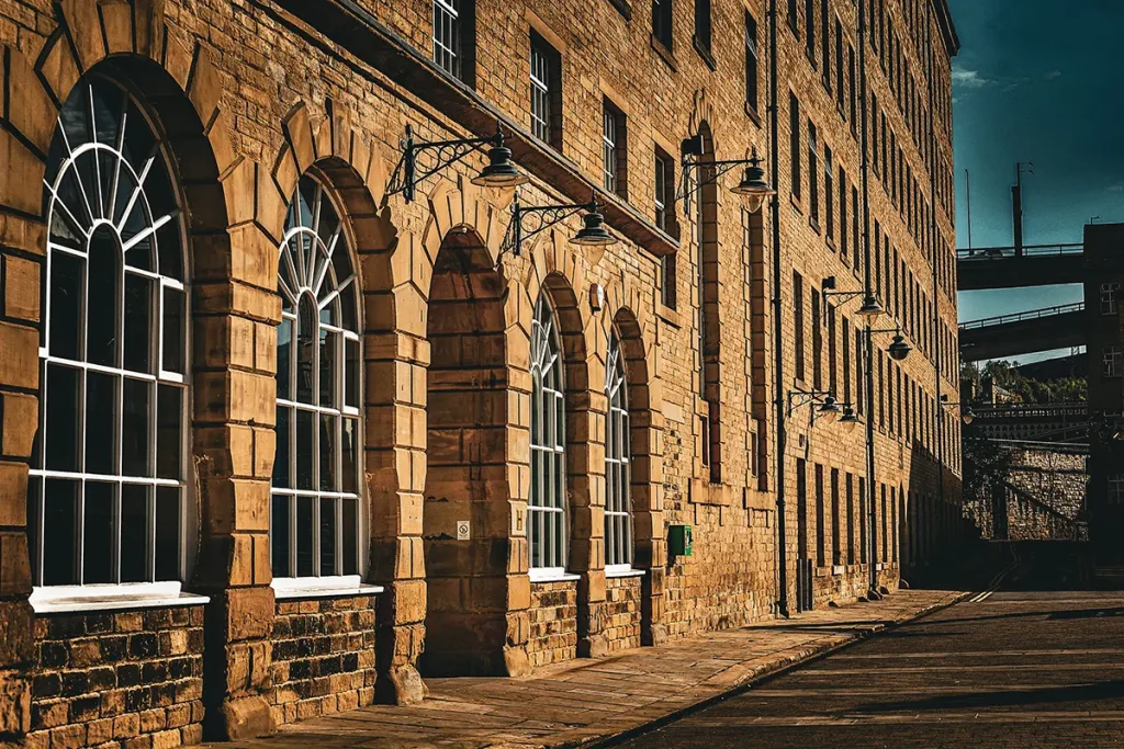Architectural photo of Dean Clough mill complex in Halifax, showing historic red-brick industrial buildings. Creative photography by Chaplin Studio.
