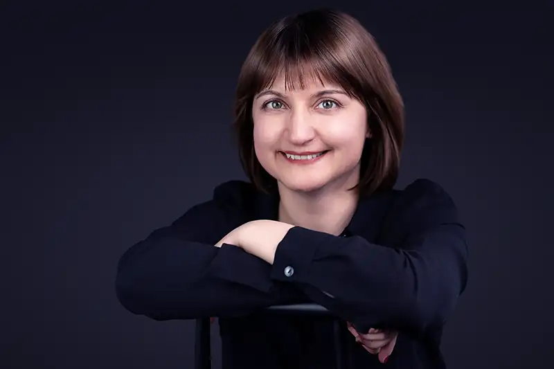 Portrait of a smiling woman wearing a black outfit, photographed by Chaplin Studio - Photography Studio Halifax
