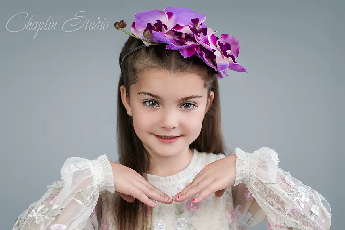Elegant studio portrait of a young girl wearing a floral headpiece – children's photography by Chaplin Studio