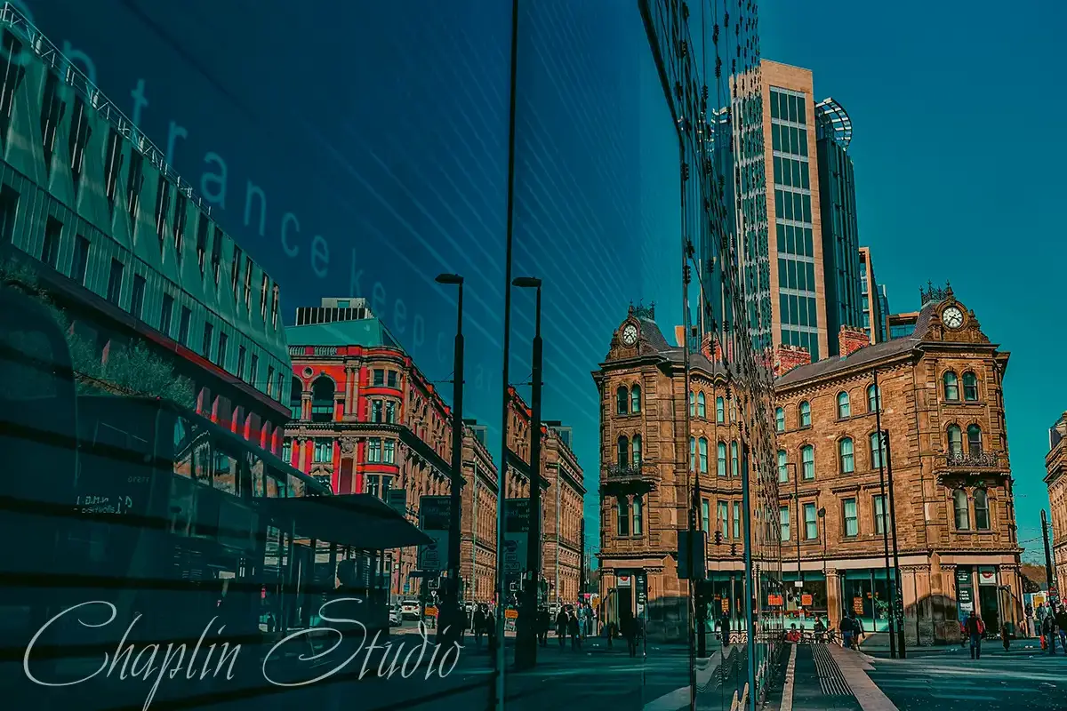 A vibrant city street scene showcasing a reflection of historic buildings in the glass facade of a modern skyscraper, blending old and new architecture under a clear blue sky, captured by Chaplin Studio.