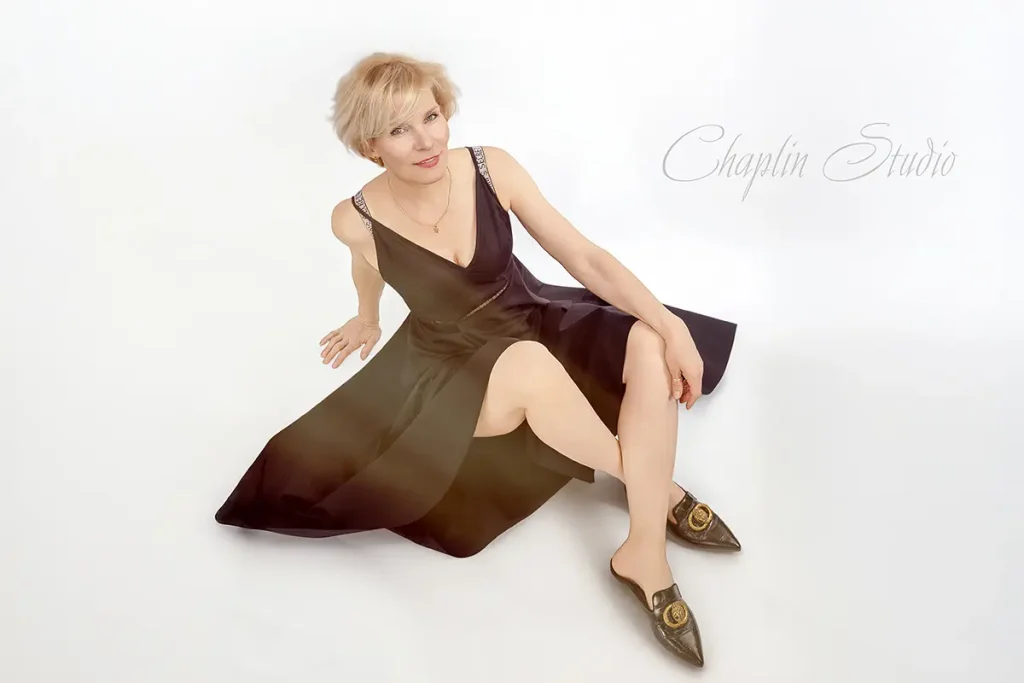 Elegant portrait of a mature woman in a black dress, taken by Chaplin Studio in Yorkshire.