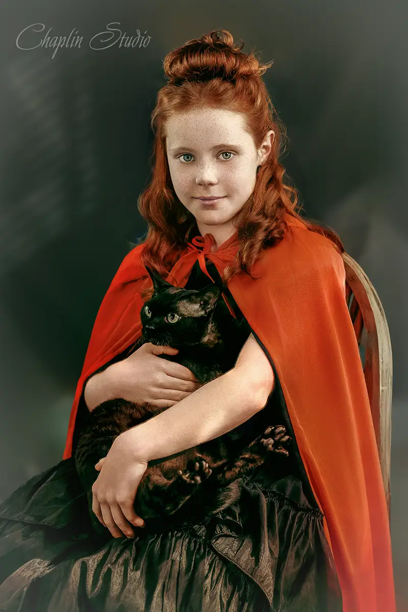 Fine art child portrait of a red-haired girl holding a black cat, Child Portrait by Chaplin Studio in classic painterly style.