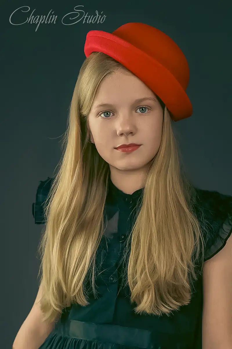 Girl with long blonde hair and red hat