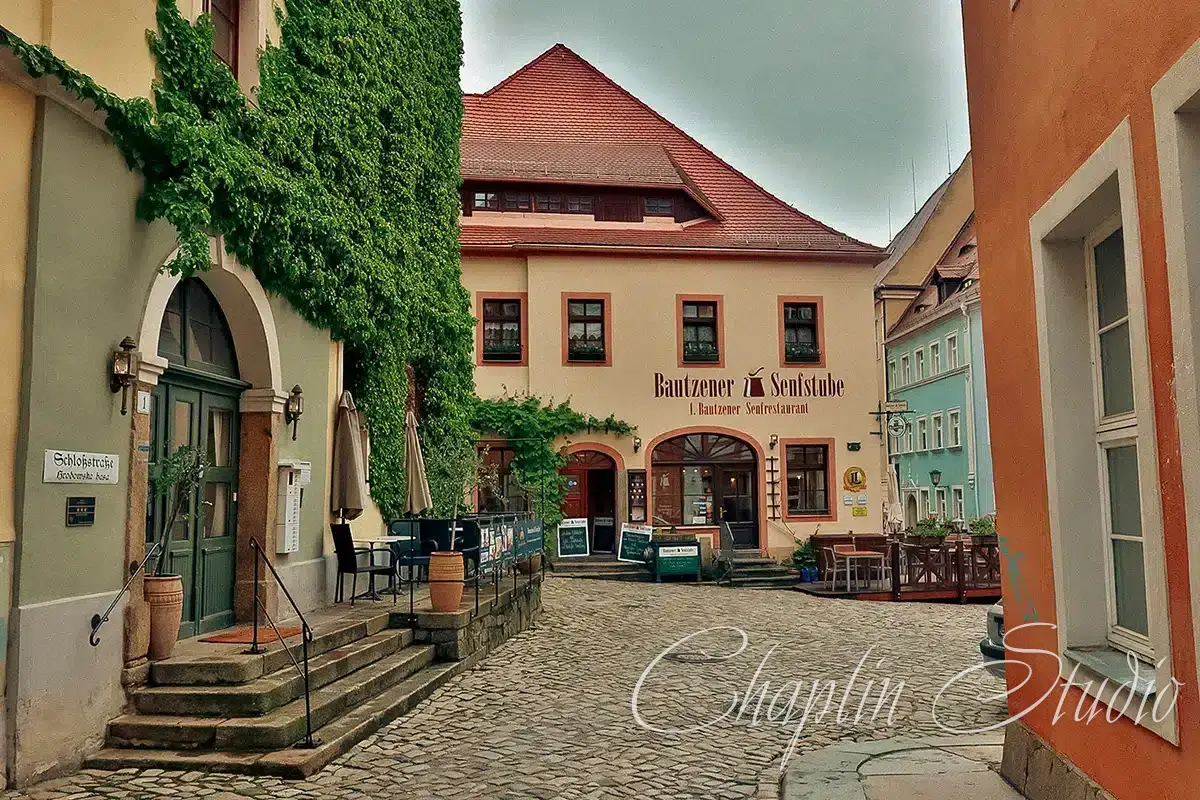 Charming historic German street with a traditional restaurant and cobblestone ground, ideal for urban travel photography.