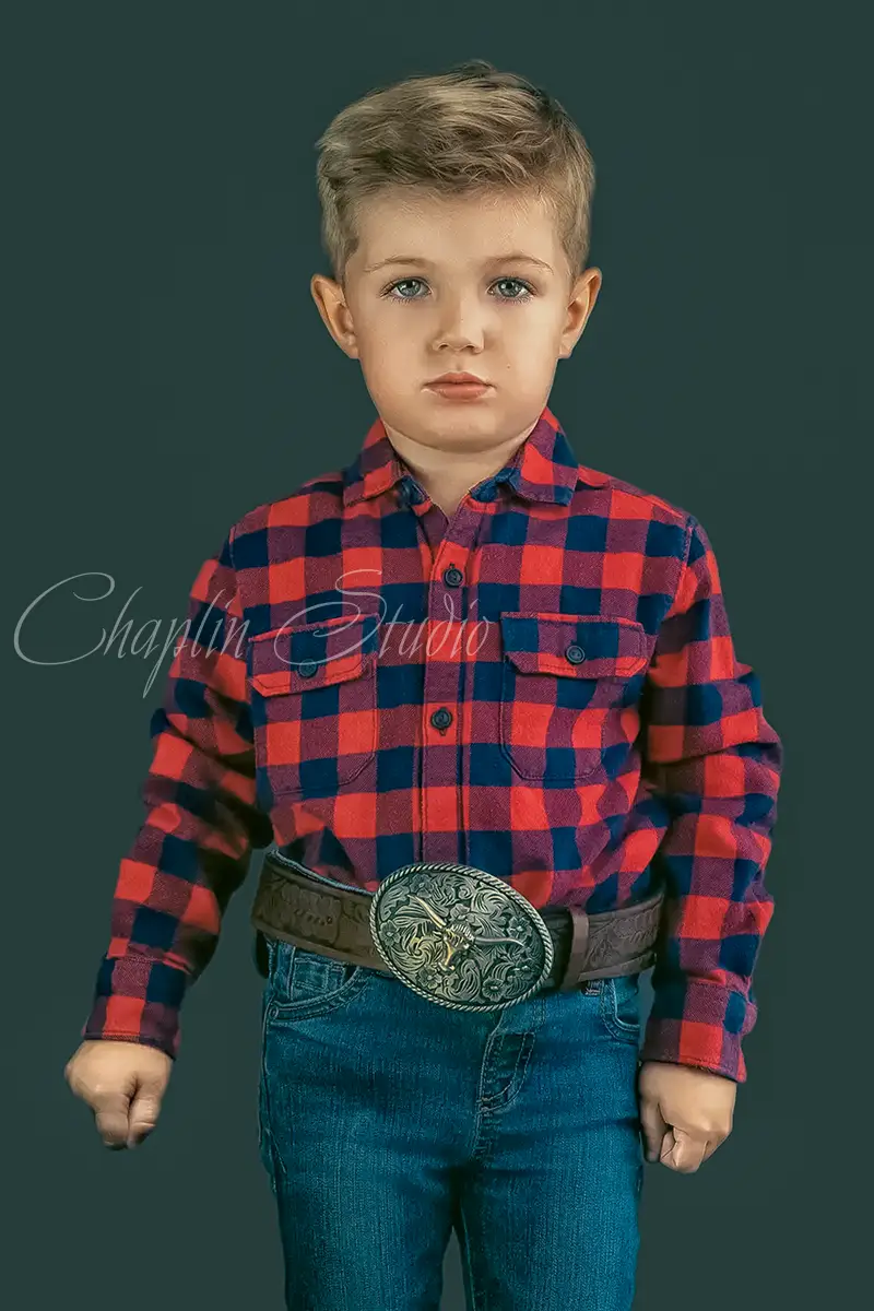 Little boy wearing a red plaid shirt and jeans — natural and warm portrait by Chaplin Studio