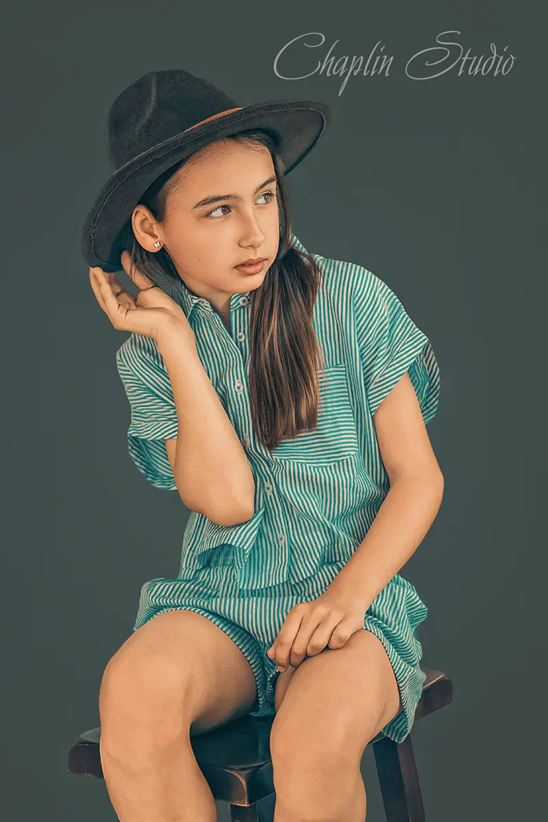 A child in a brown vintage hat, captured in a whimsical fine art portrait, showcasing creative child photography by Chaplin Studio in Yorkshire.