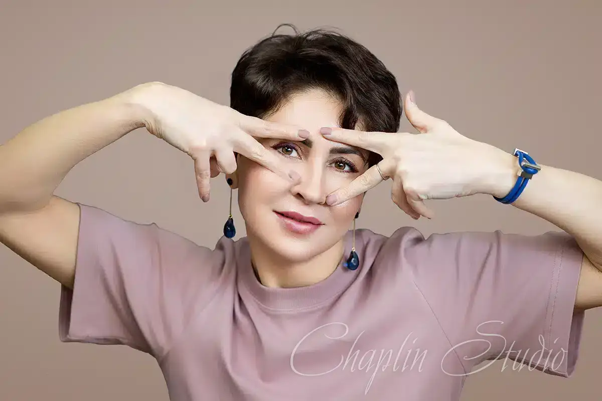 Modern studio portrait showcasing a cheerful and artistic moment, ideal for creative sessions with Chaplin Studio.