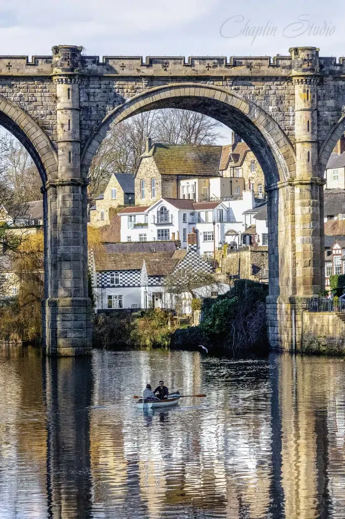 Photography of a rowing boat on the River Nidd beneath Knaresborough Viaduct in North Yorkshire, England, by Chaplin Studio.