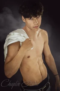 Studio portrait of a young boxer with a bare torso and a towel over his shoulder, captured in Halifax.